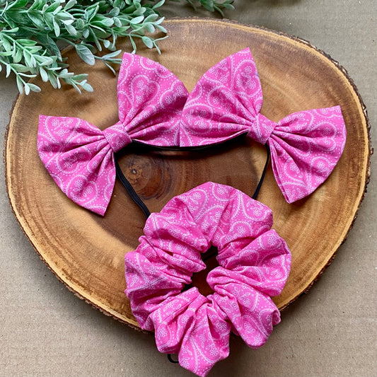 Pink paisley cotton scrunchie from Bully Love Boutique, featuring a soft fabric and elastic hair accessory design.