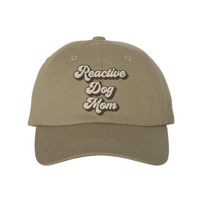 Reactive Dog Mom hat by Bully Love Boutique, beige fabric with black text and adjustable strap, casual accessory for dog moms.