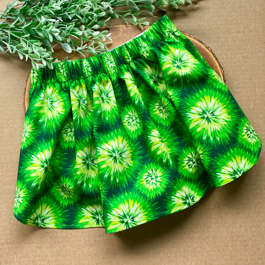 Green tie-dye dog skirt from Bully Love Boutique, featuring vibrant fabric and adjustable waistband for a stylish pet look.